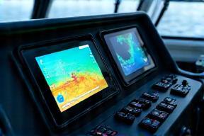 Modern fish finder and marine electronics installed on a boat console